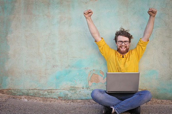 happy man with laptop
